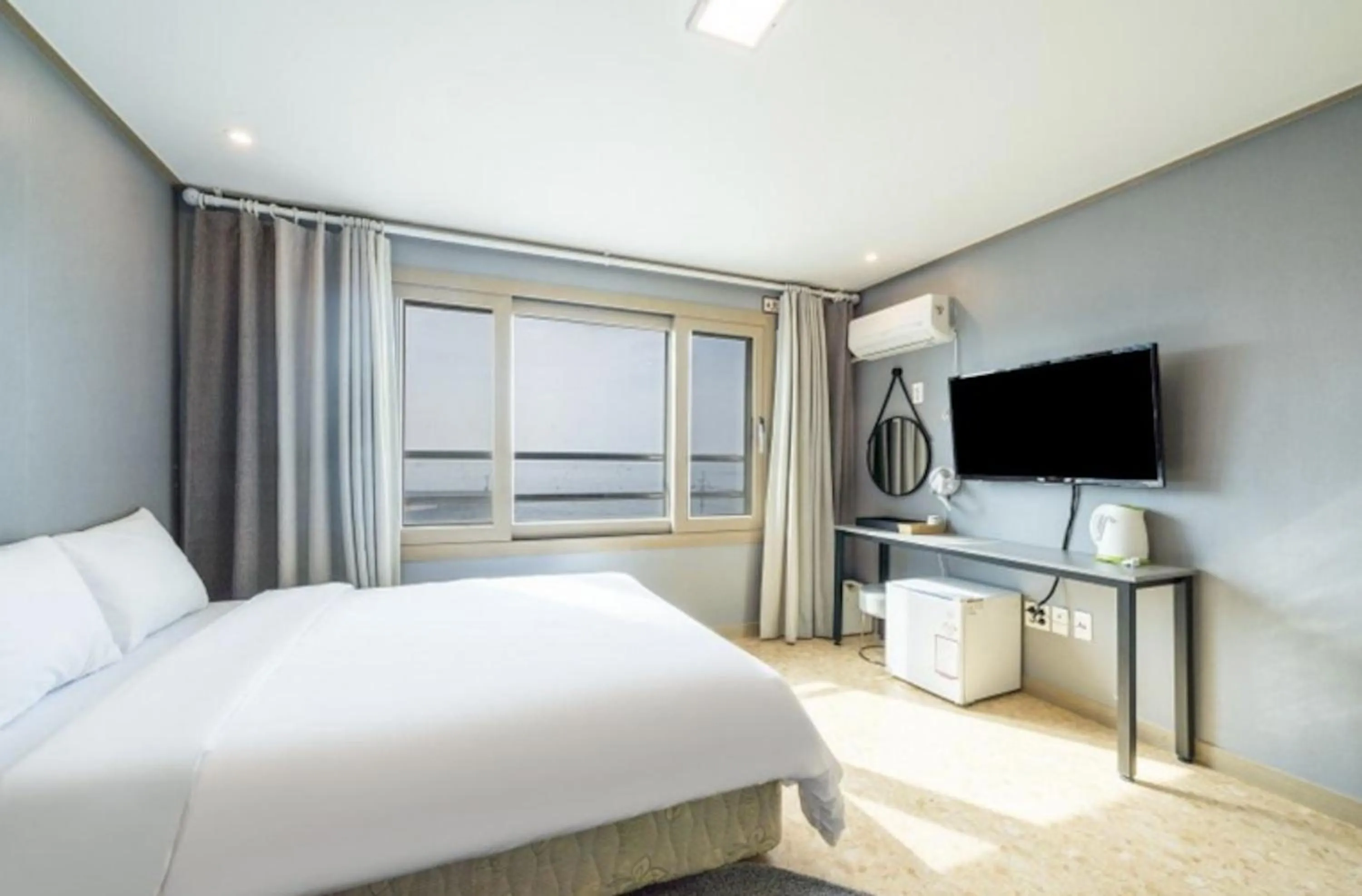 Bed in Jeju Pure Stay Ocean