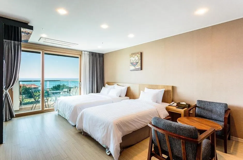 Seating area, Bed in Rich Hotel