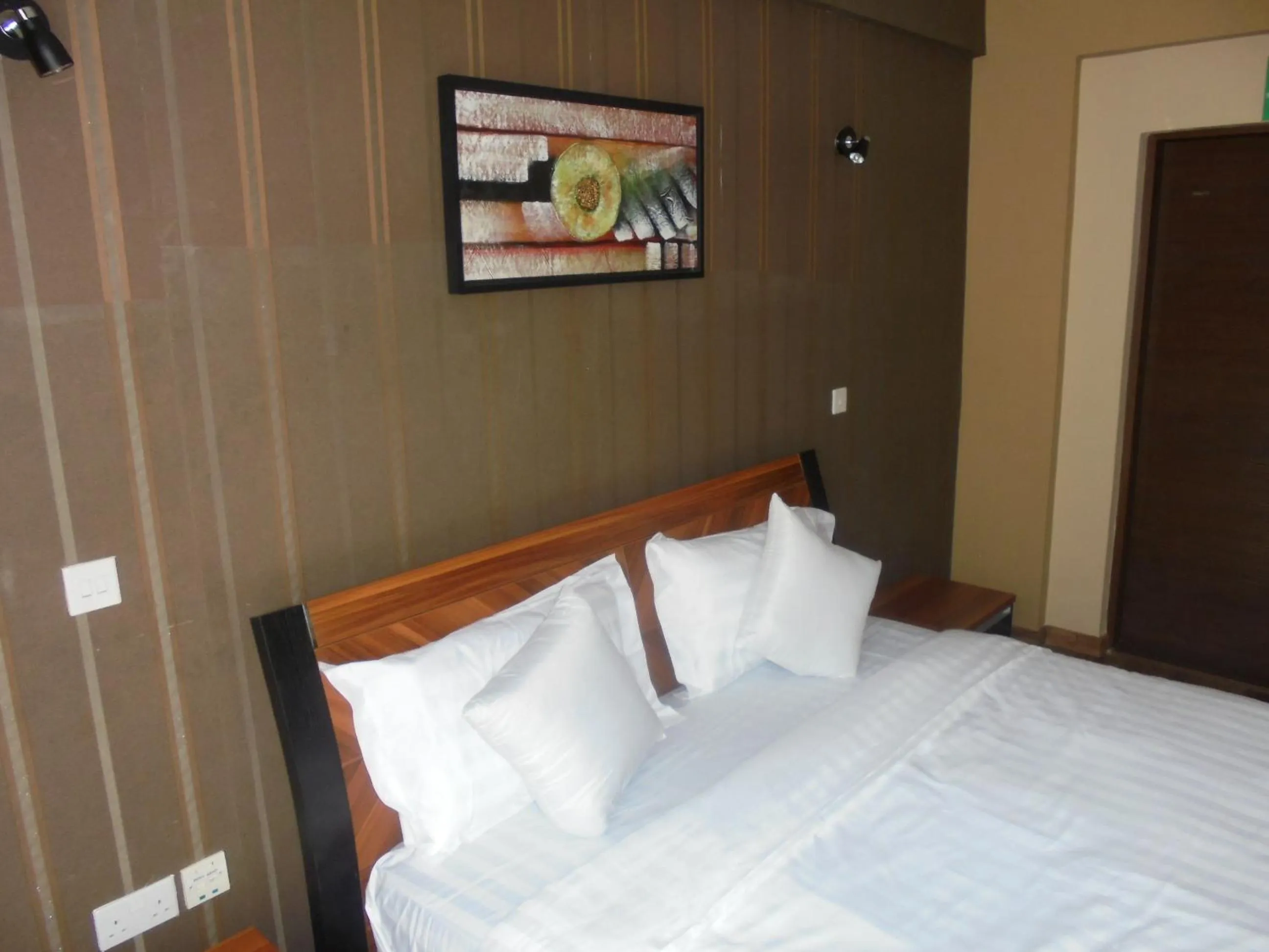 Bed in We Hotel and Suites