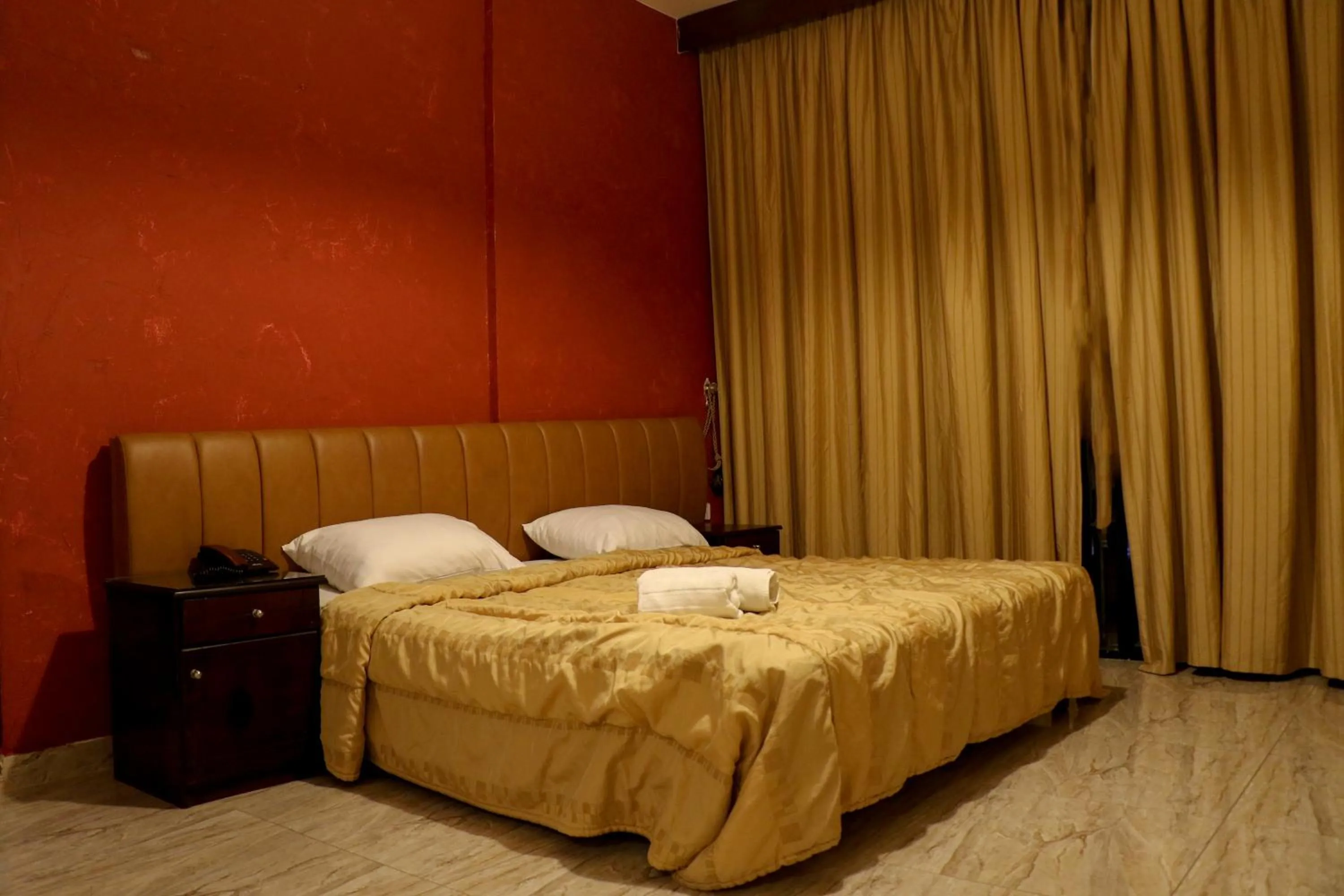 Bed in Grand Suites Hotel