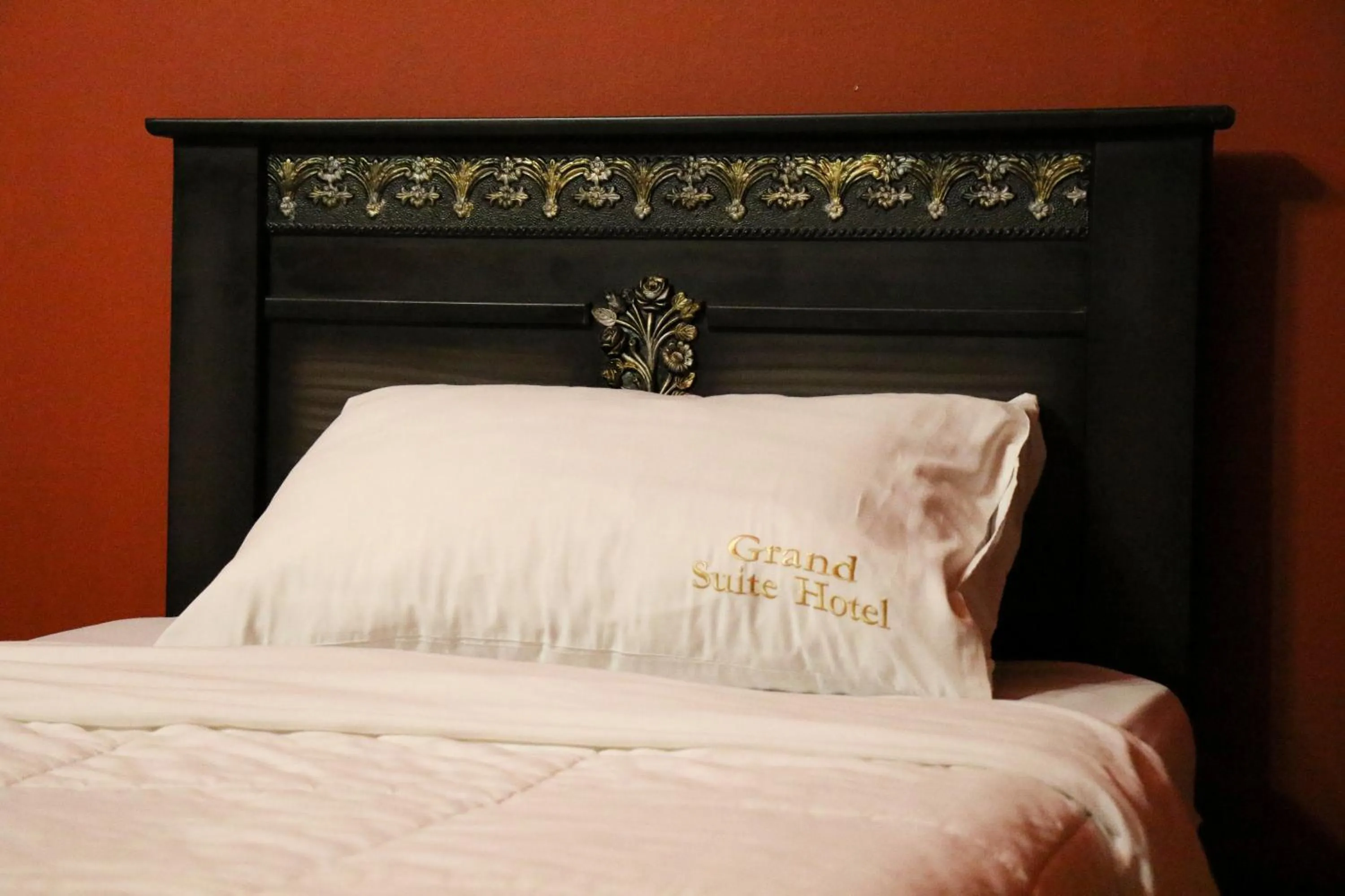 Bed in Grand Suites Hotel