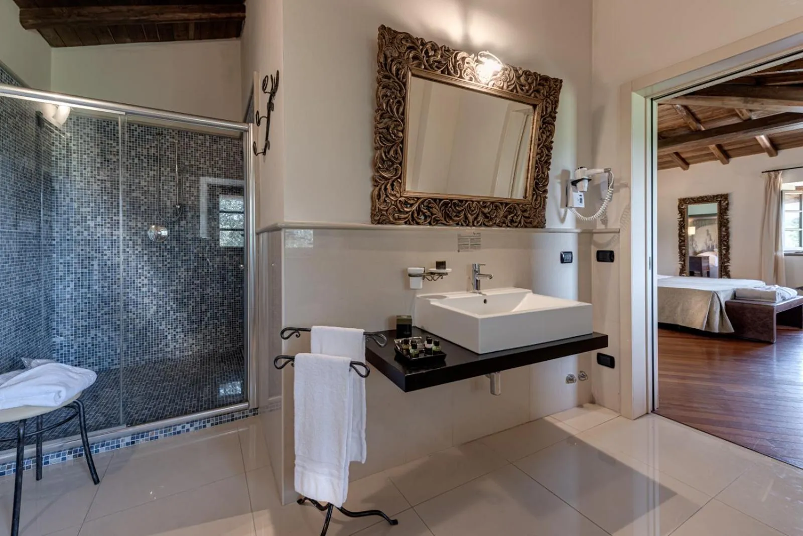 Bathroom, Bed in Villa Campomaggio Resort & SPA