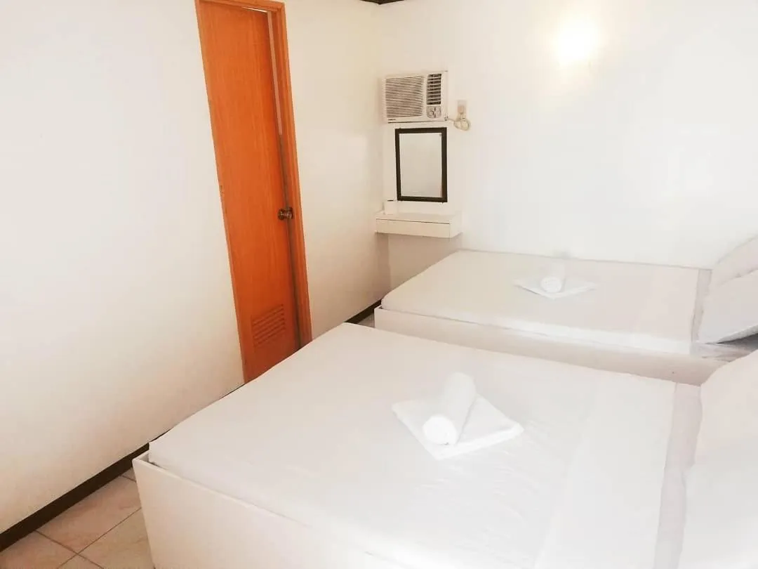 Bed in The Waterfront Beach Resort