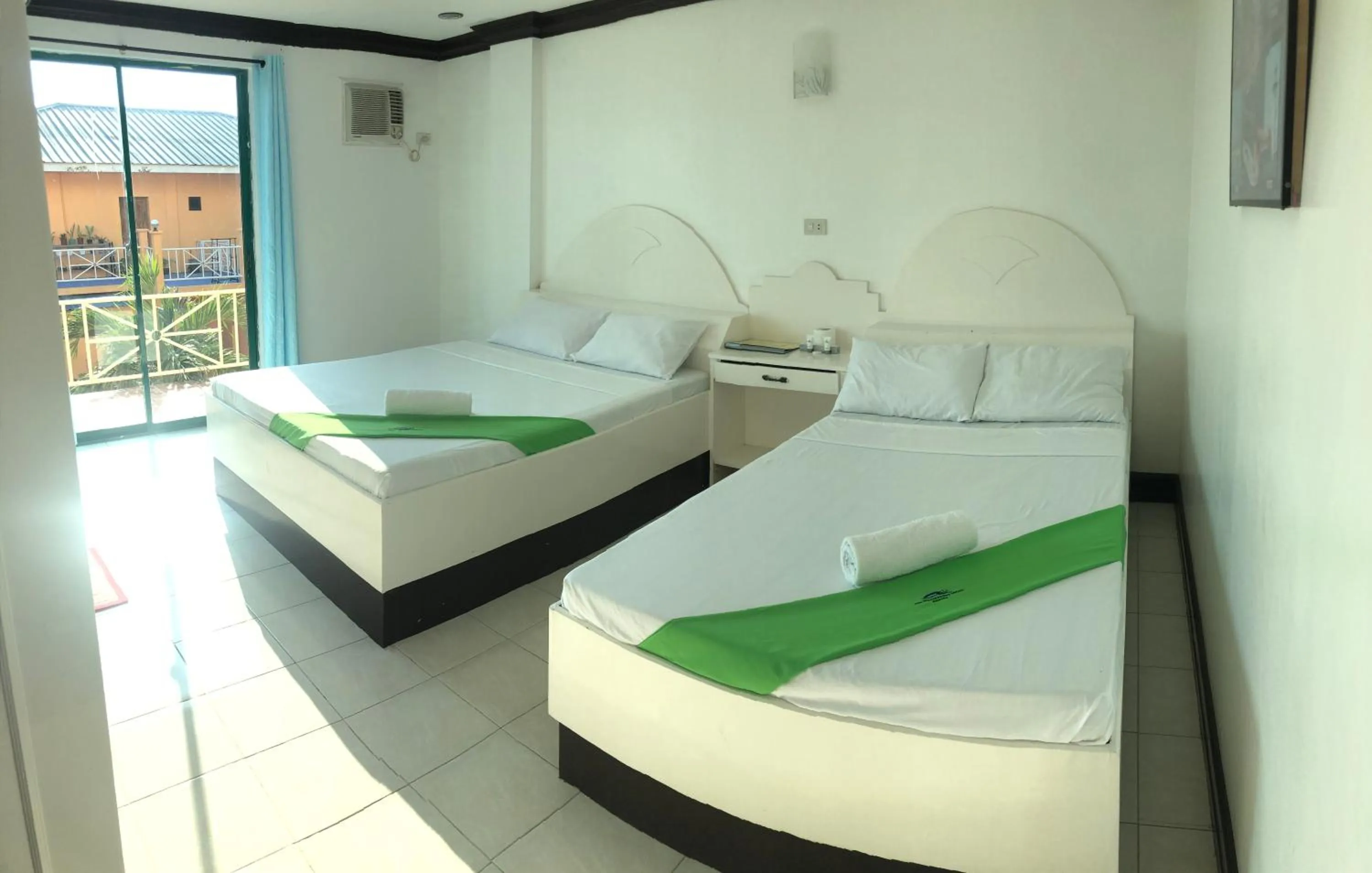 Bed in The Waterfront Beach Resort