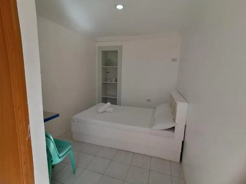 Bed in The Waterfront Beach Resort