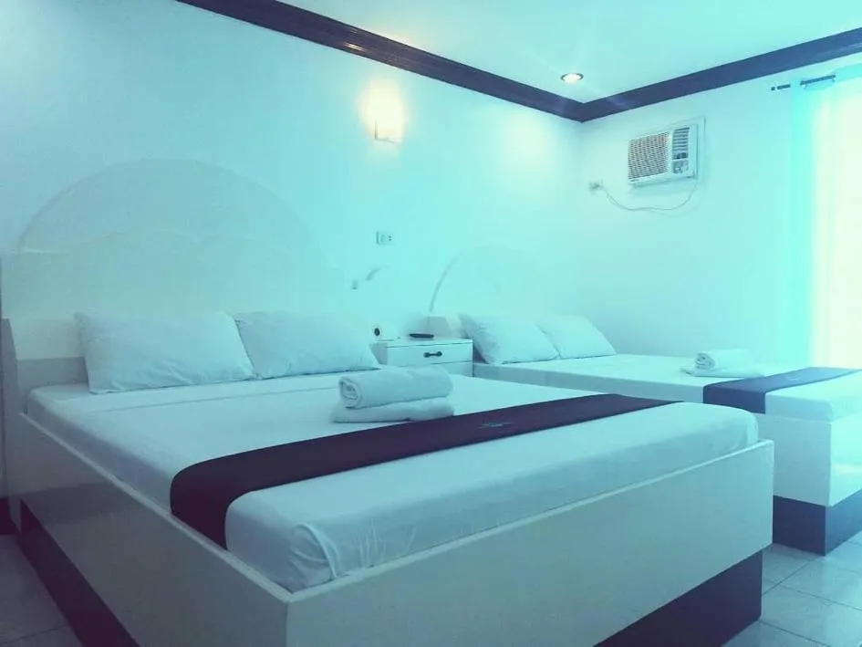 Bed in The Waterfront Beach Resort