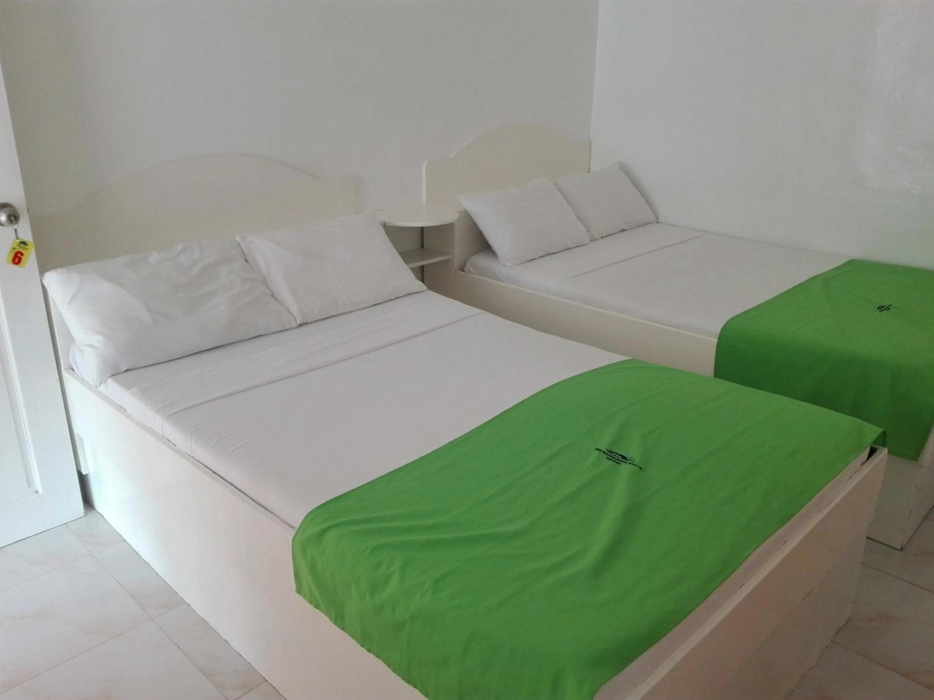 Bed in The Waterfront Beach Resort