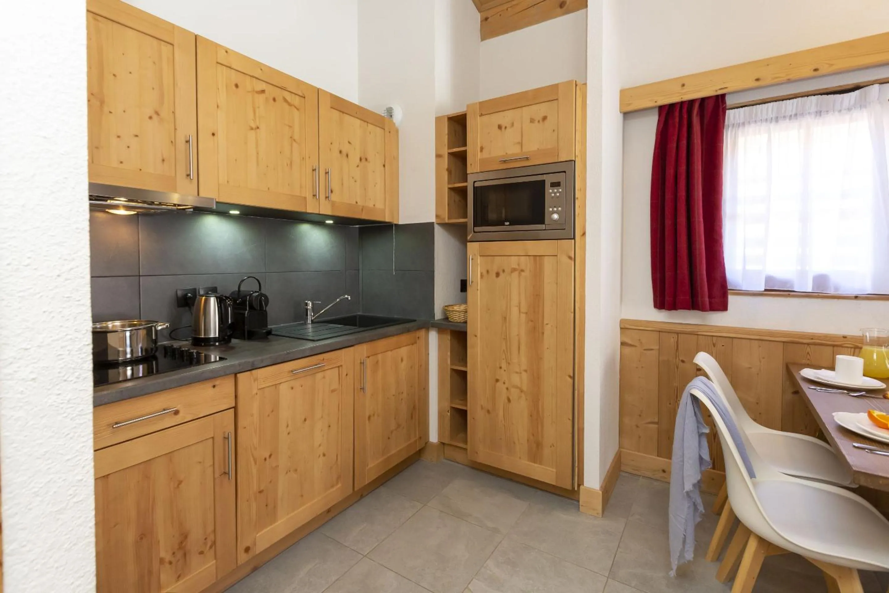 Kitchen or kitchenette in Résidence Odalys Les Fermes de Châtel