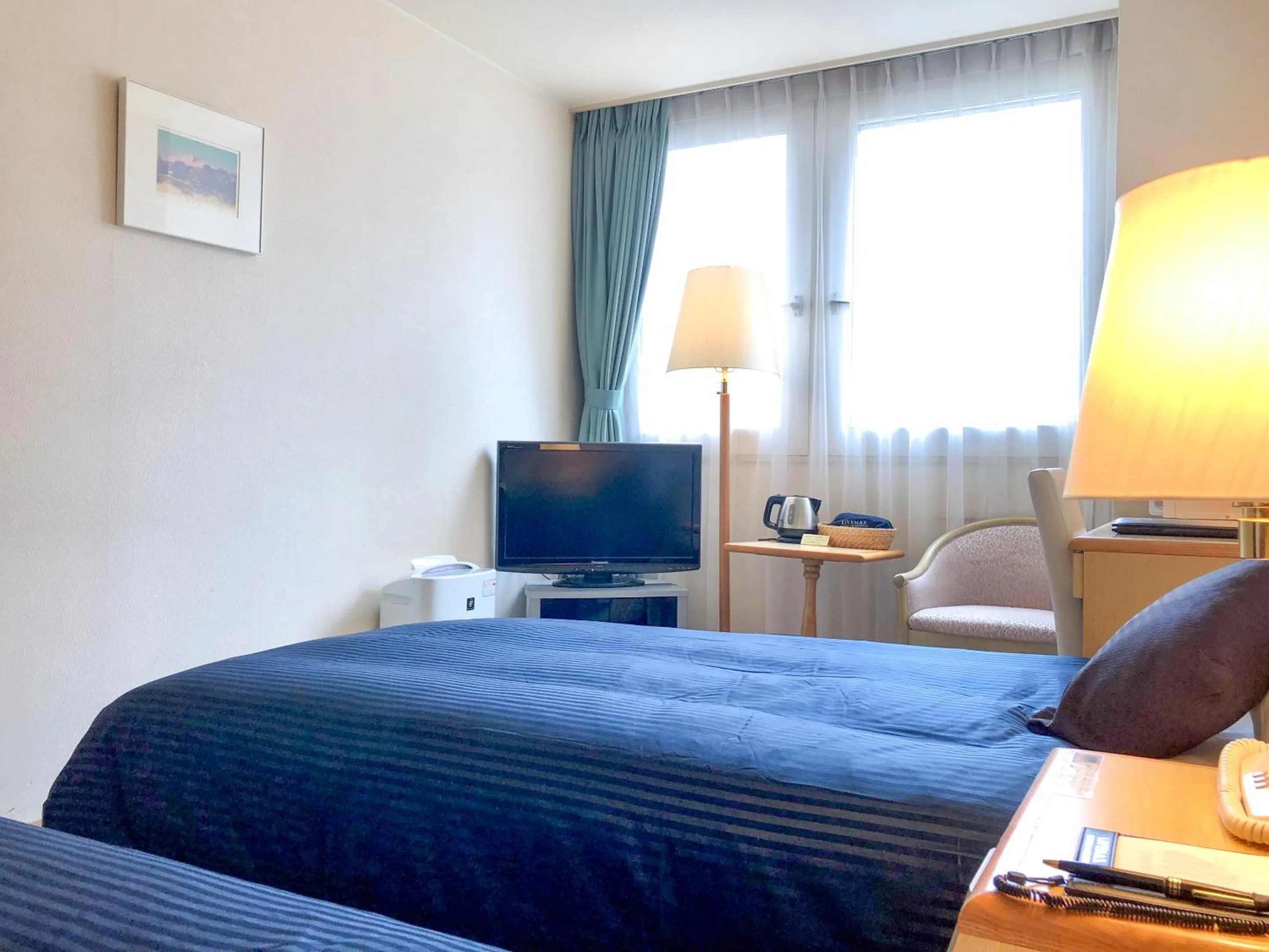 Photo of the whole room, Bed in HOTEL LiVEMAX Sapporo Ekimae