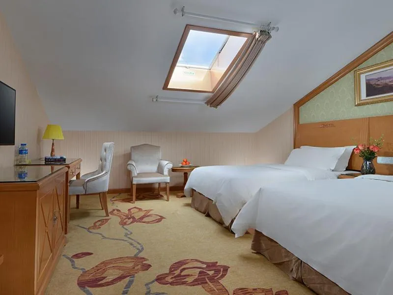 Bed in Vienna International Hotel Lijiang Yuxue Avenue