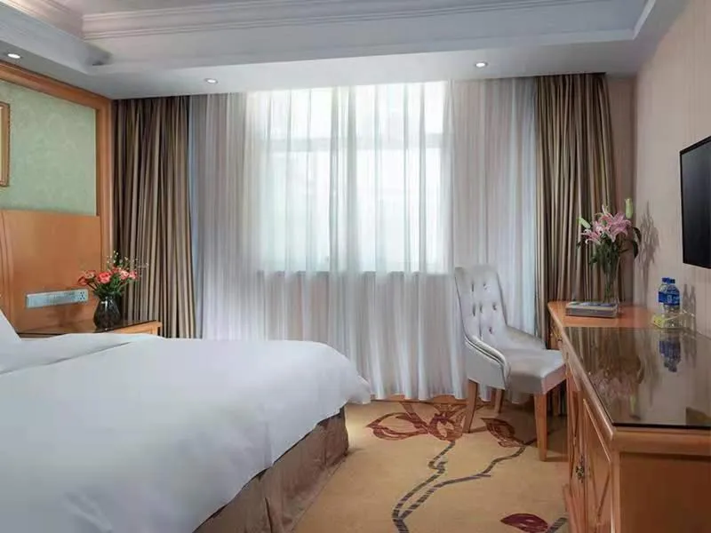 Bed in Vienna International Hotel Lijiang Yuxue Avenue