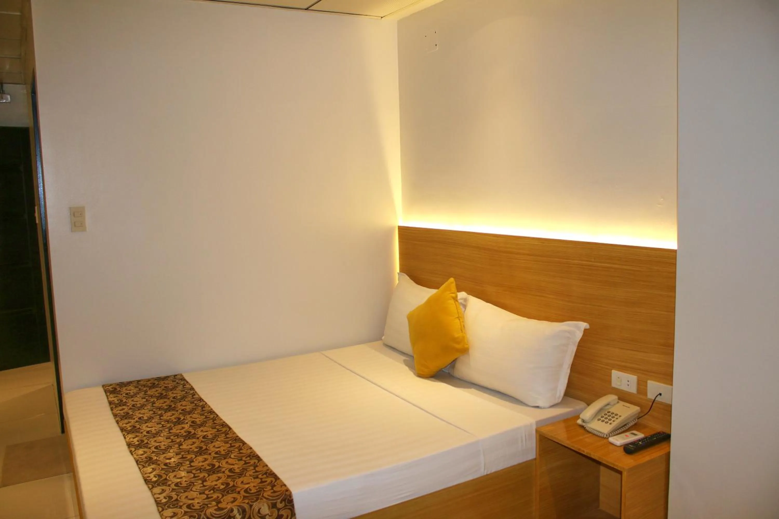Bed in LuxeLite Suites Pasay
