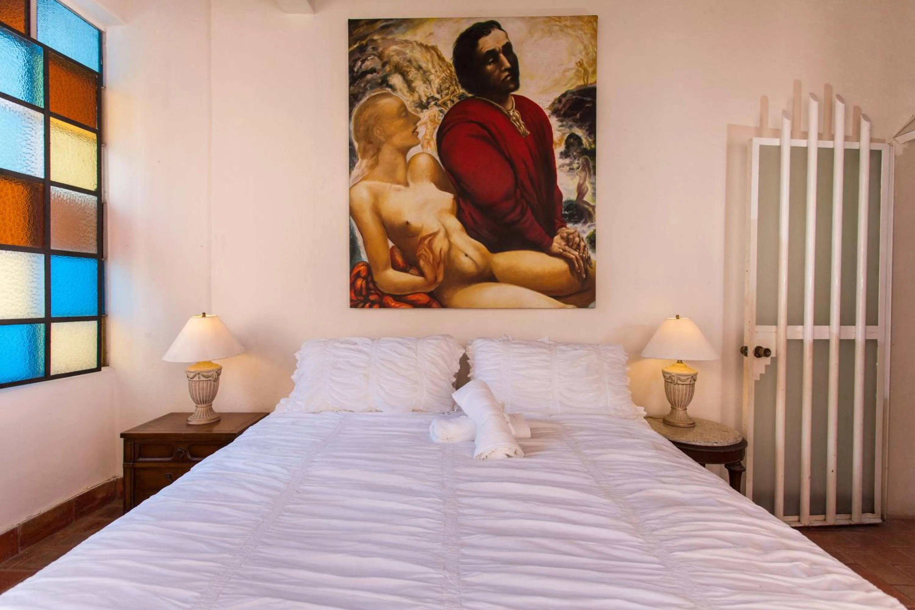 Bed in Garlands Del Rio Riverside Boutique Hotel