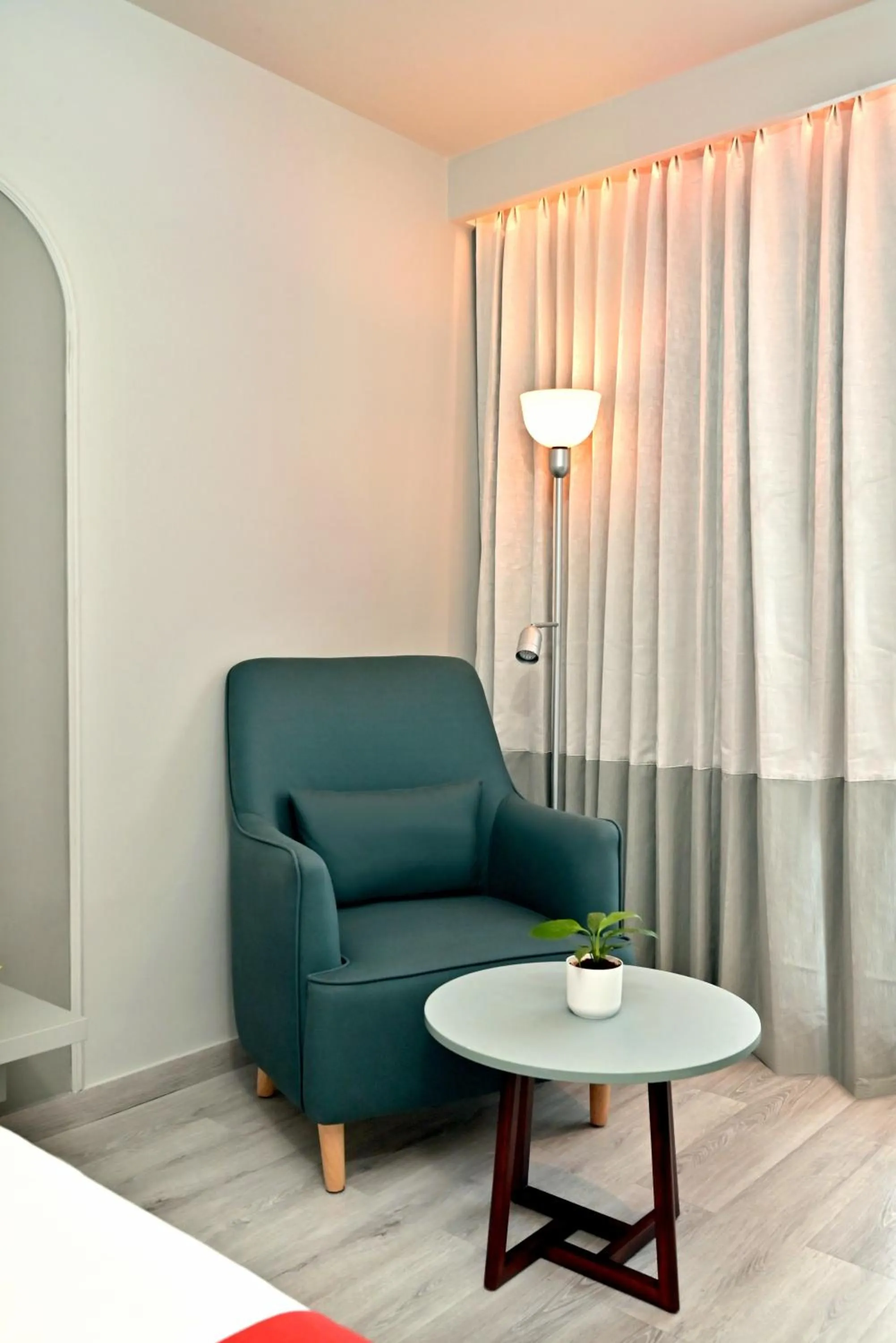 Seating area, Bed in Ira by Orchid Hyderabad Hitech City Mindspace IT Park