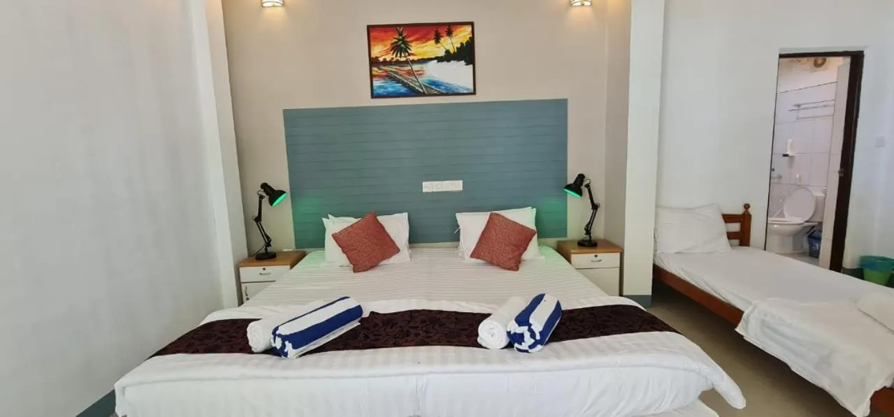 Bed in Liberty Guesthouse Maldives