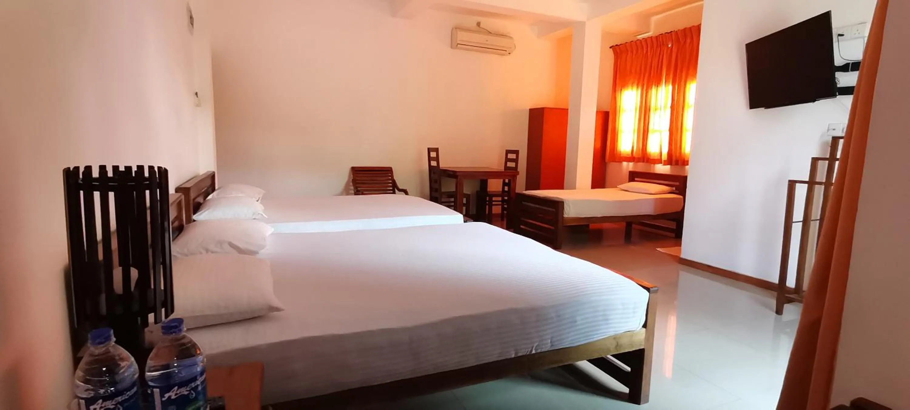 Communal lounge/ TV room, Bed in Rajarata Family Resort