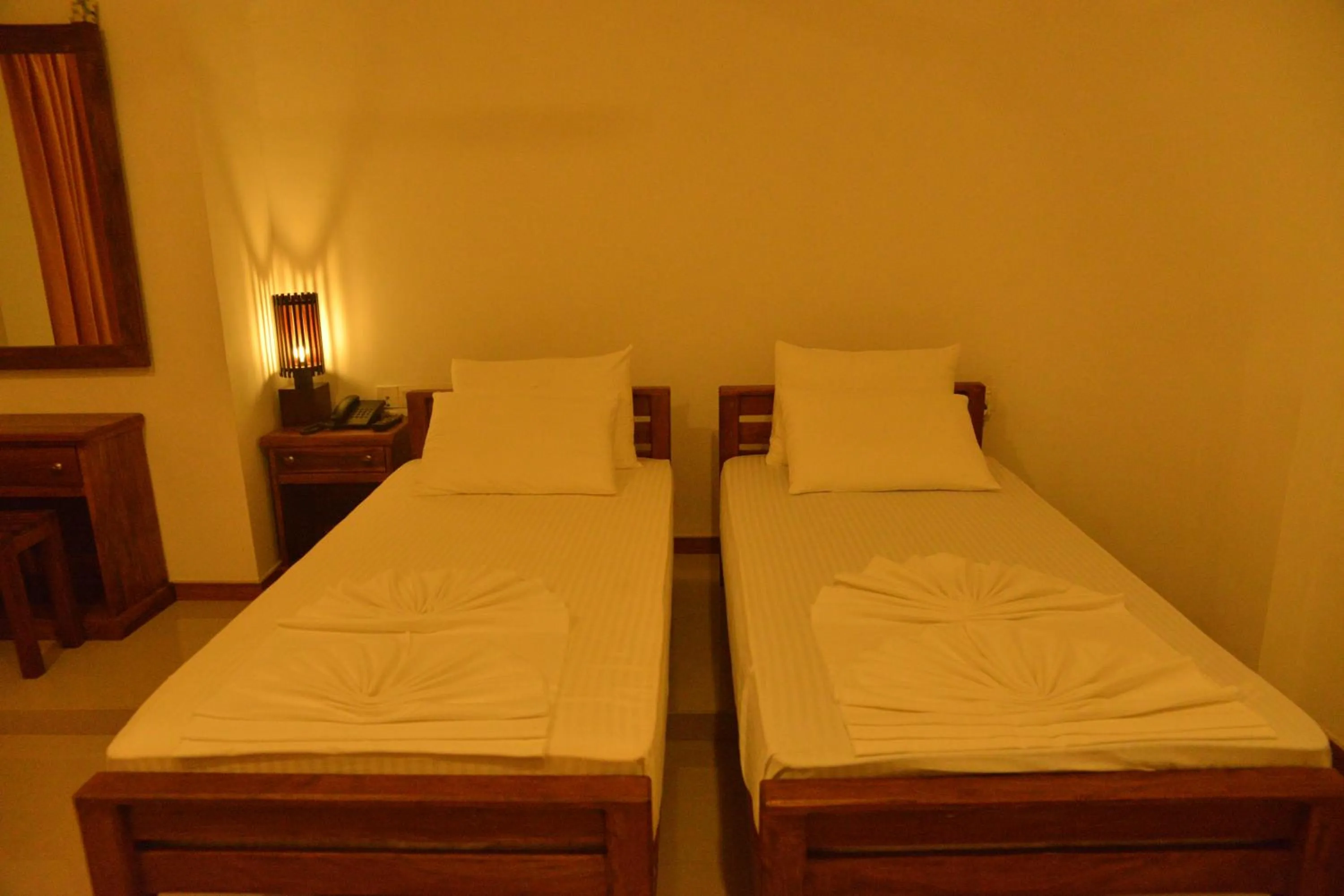 Bed in Rajarata Family Resort