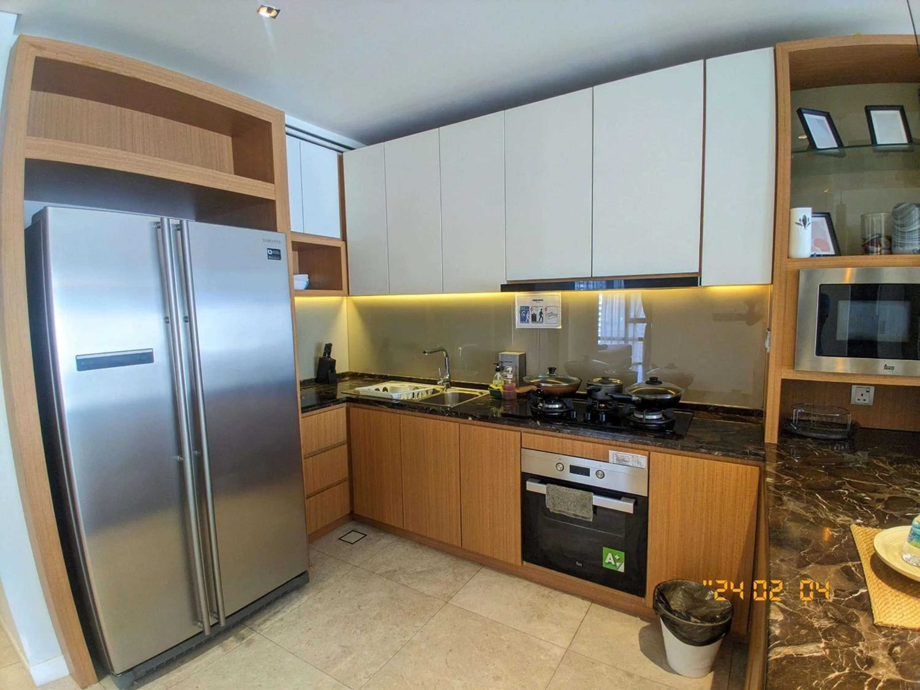 Kitchen or kitchenette in Leo Guesthouse at Anggun Residence Suite