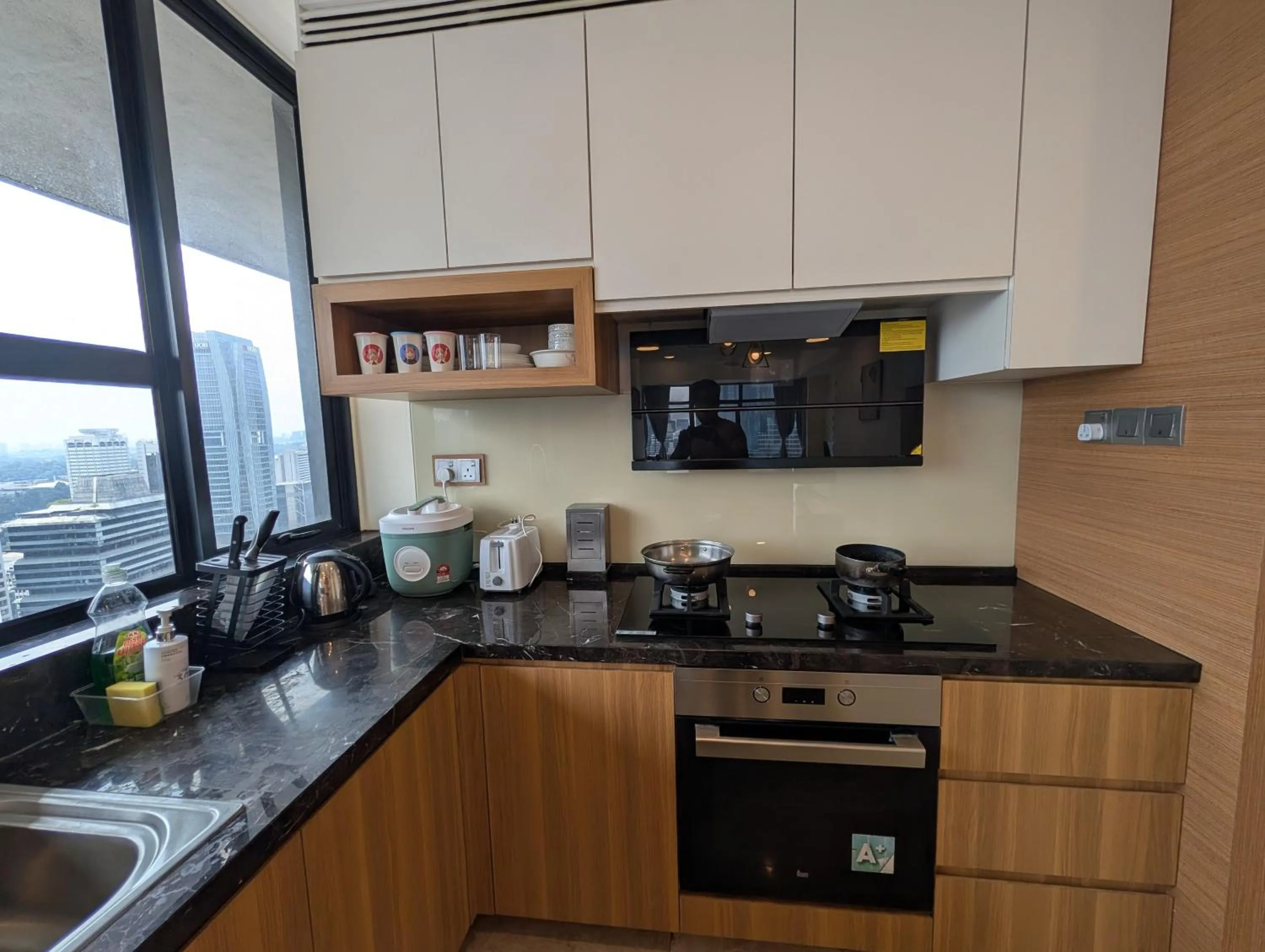 Kitchen or kitchenette in Leo Guesthouse at Anggun Residence Suite