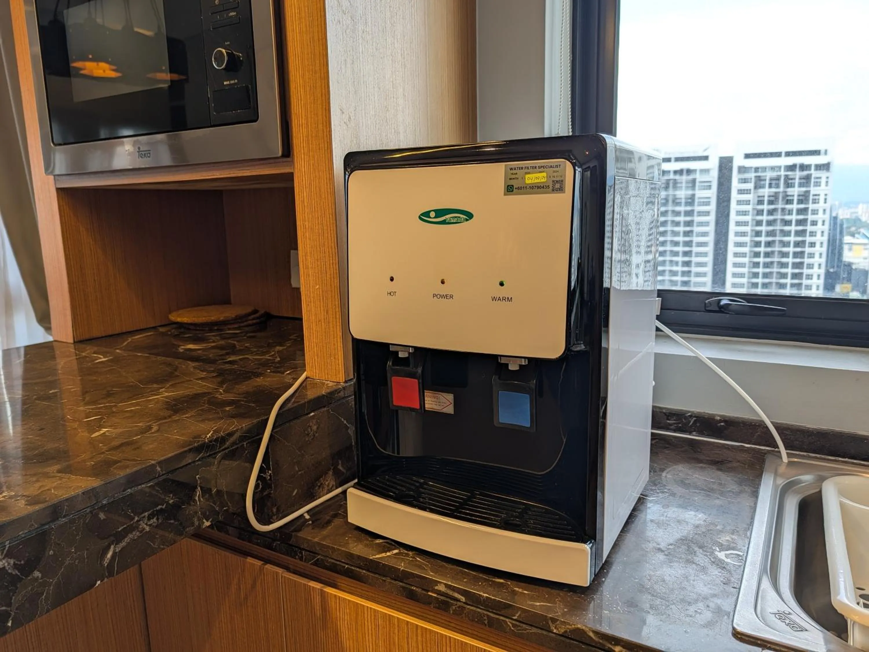 Kitchen or kitchenette in Leo Guesthouse at Anggun Residence Suite