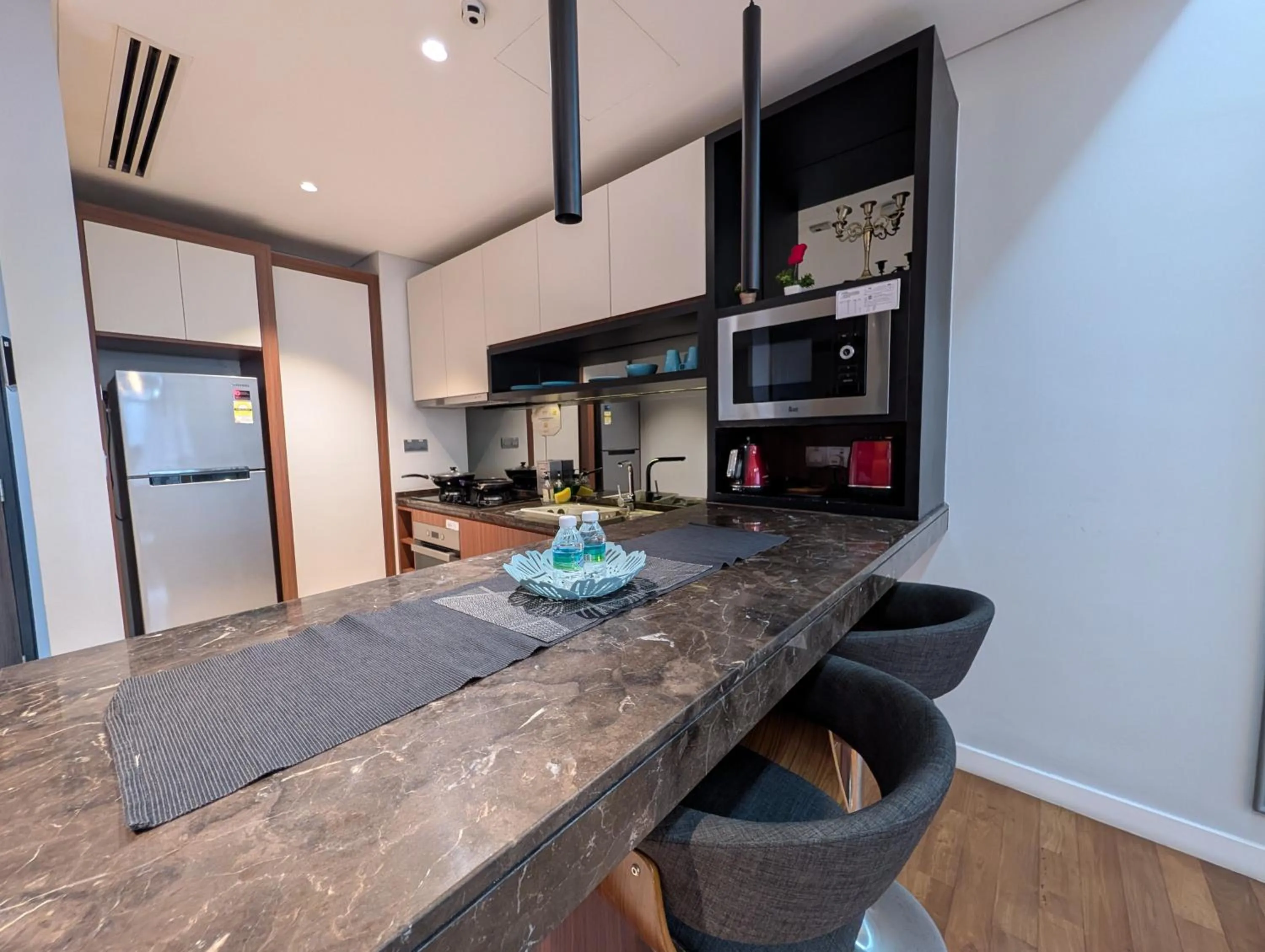 Kitchen or kitchenette in Leo Guesthouse at Anggun Residence Suite