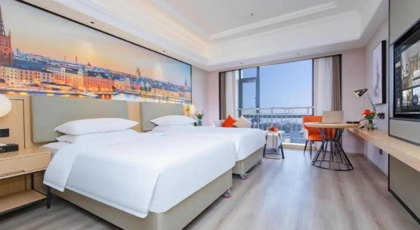 Bed in Vienna International Hotel Wuhan Huanghelou Pengliuyang Metro Station