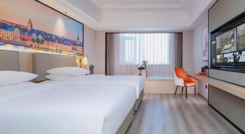 Bed in Vienna International Hotel Wuhan Huanghelou Pengliuyang Metro Station