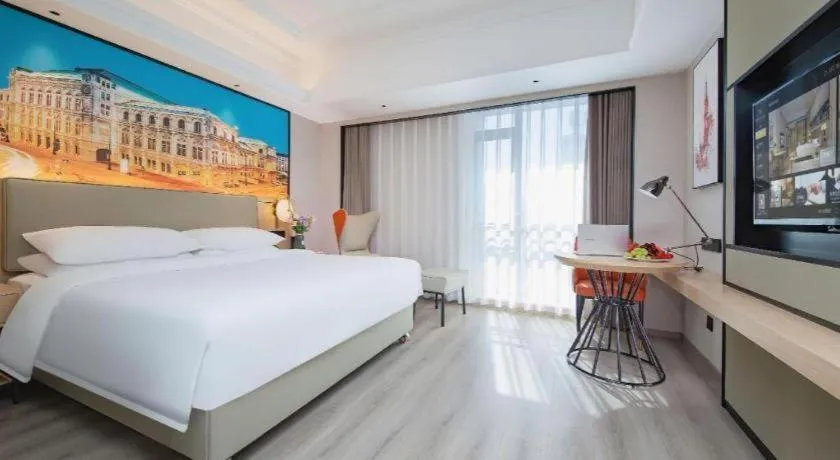 Bed in Vienna International Hotel Wuhan Huanghelou Pengliuyang Metro Station