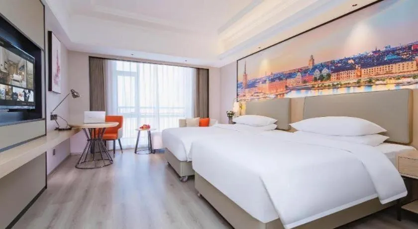 Bed in Vienna International Hotel Wuhan Huanghelou Pengliuyang Metro Station