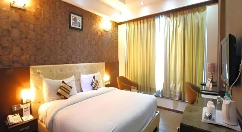 Bed in Hotel Signature Grand