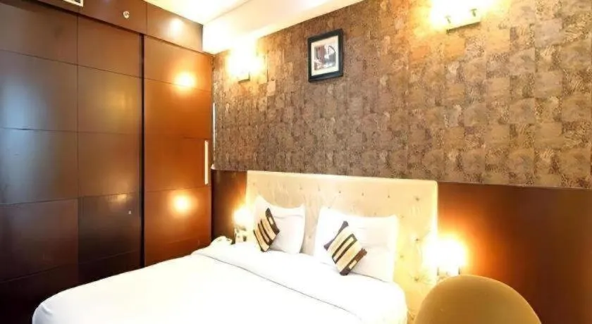 Bed in Hotel Signature Grand