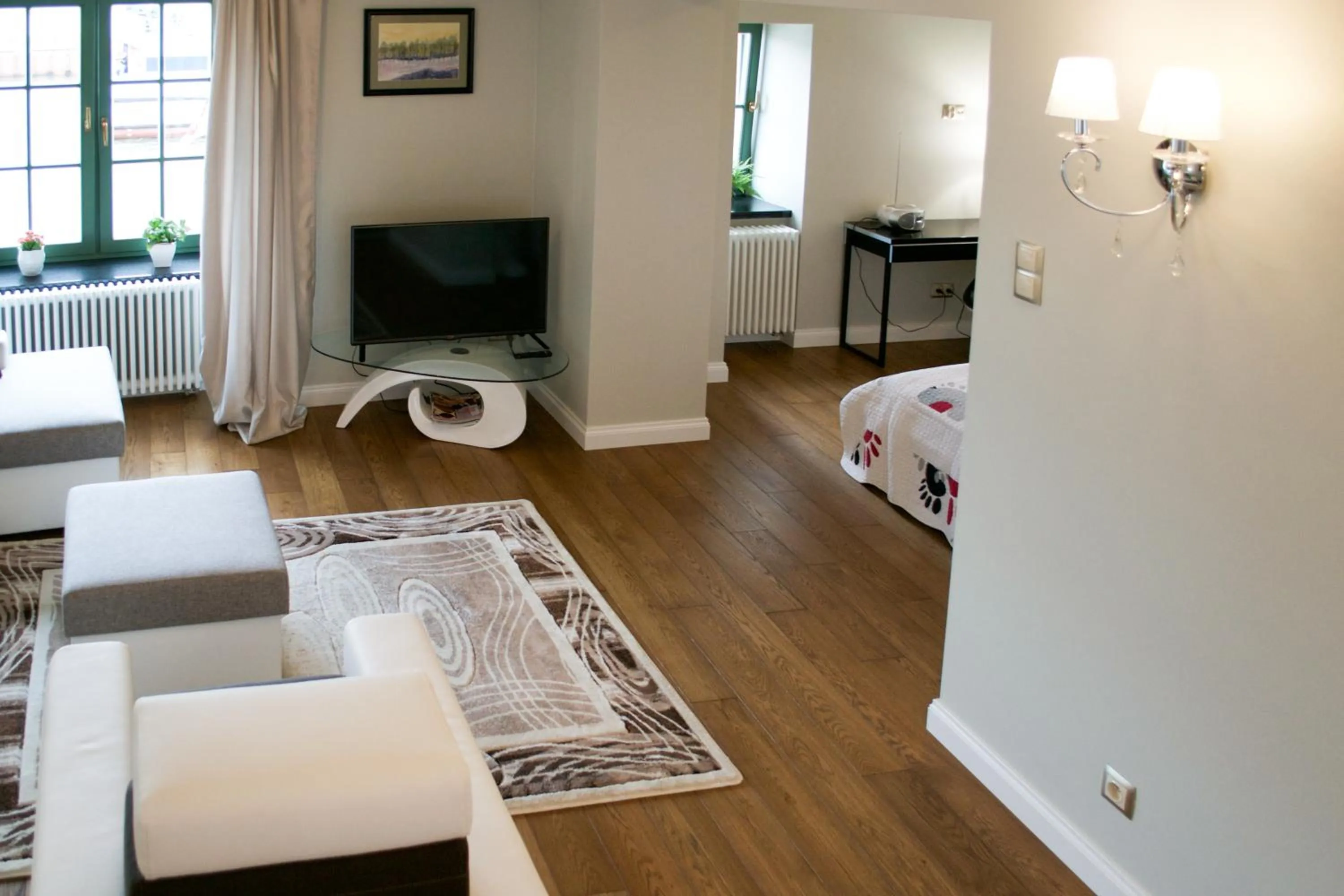 Communal lounge/ TV room in Komturia Old Town by Fahrenheit