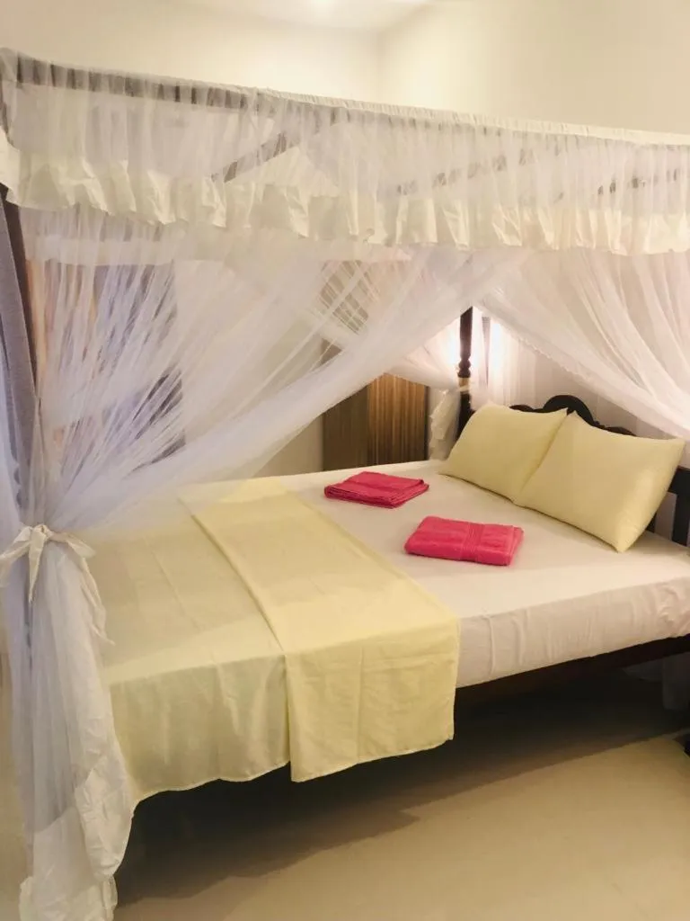 Bed in Coral Palm Villa and Apartment
