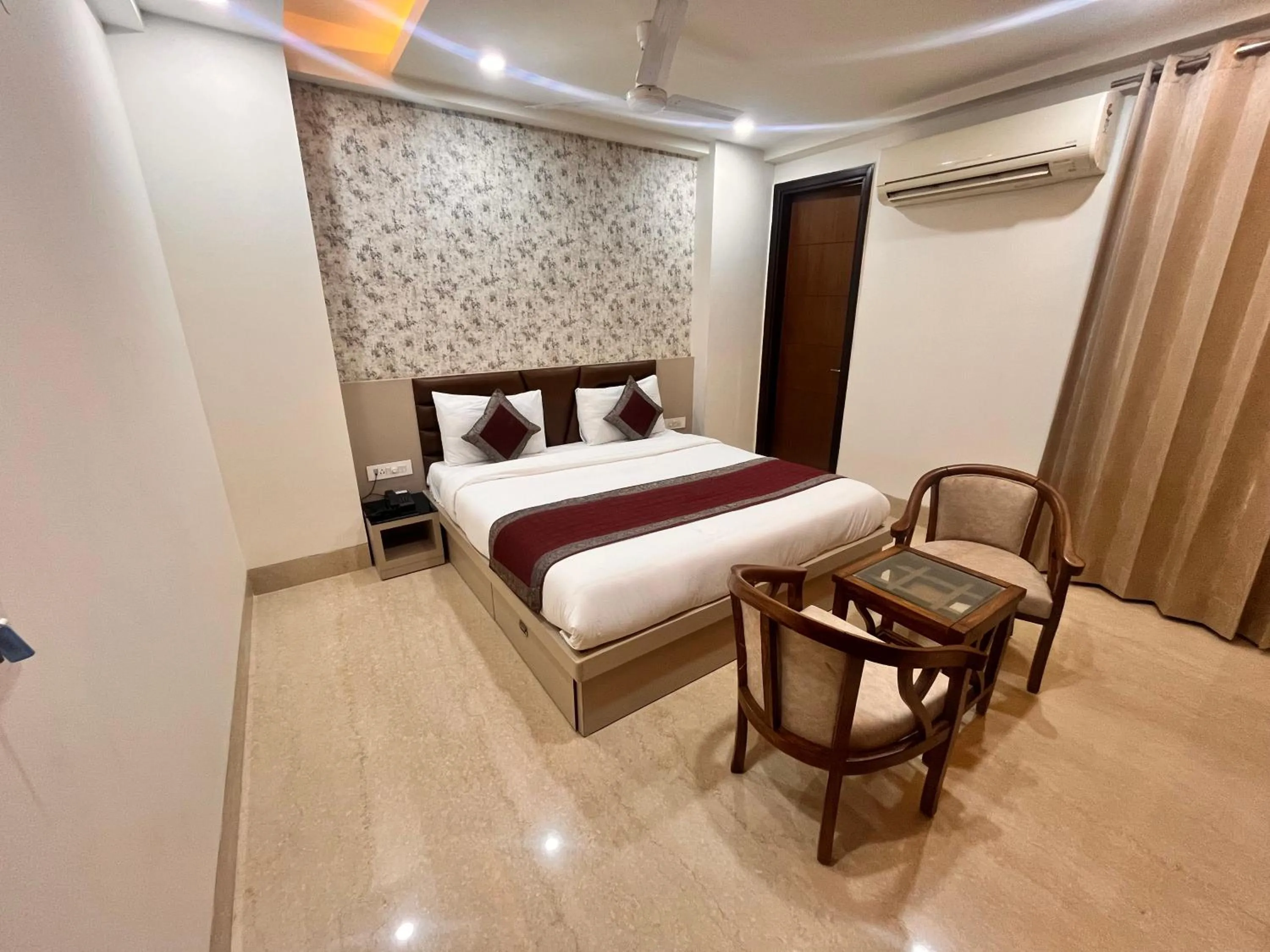 Seating area, Bed in Gazebo Inn & Suites Medanta