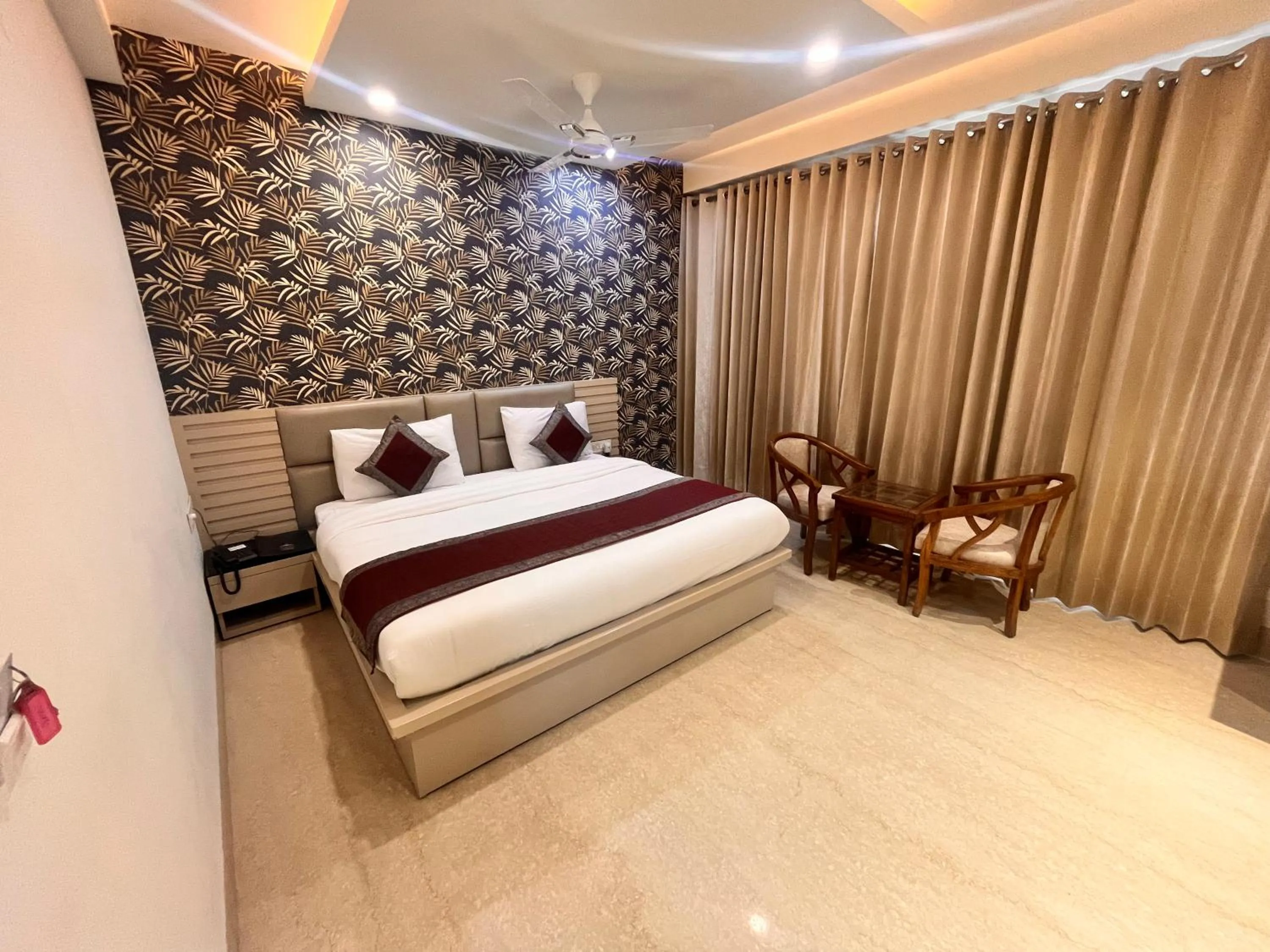 Seating area, Bed in Gazebo Inn & Suites Medanta