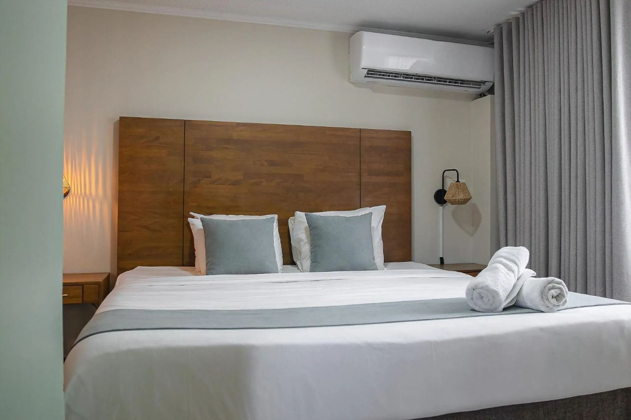 Bed in Majestic City Suites & Beach Hotel