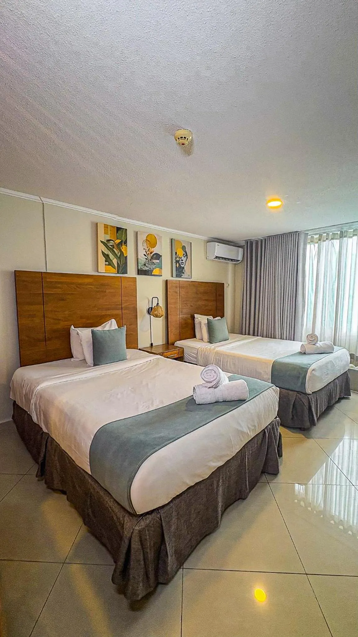 Bed in Majestic City Suites & Beach Hotel