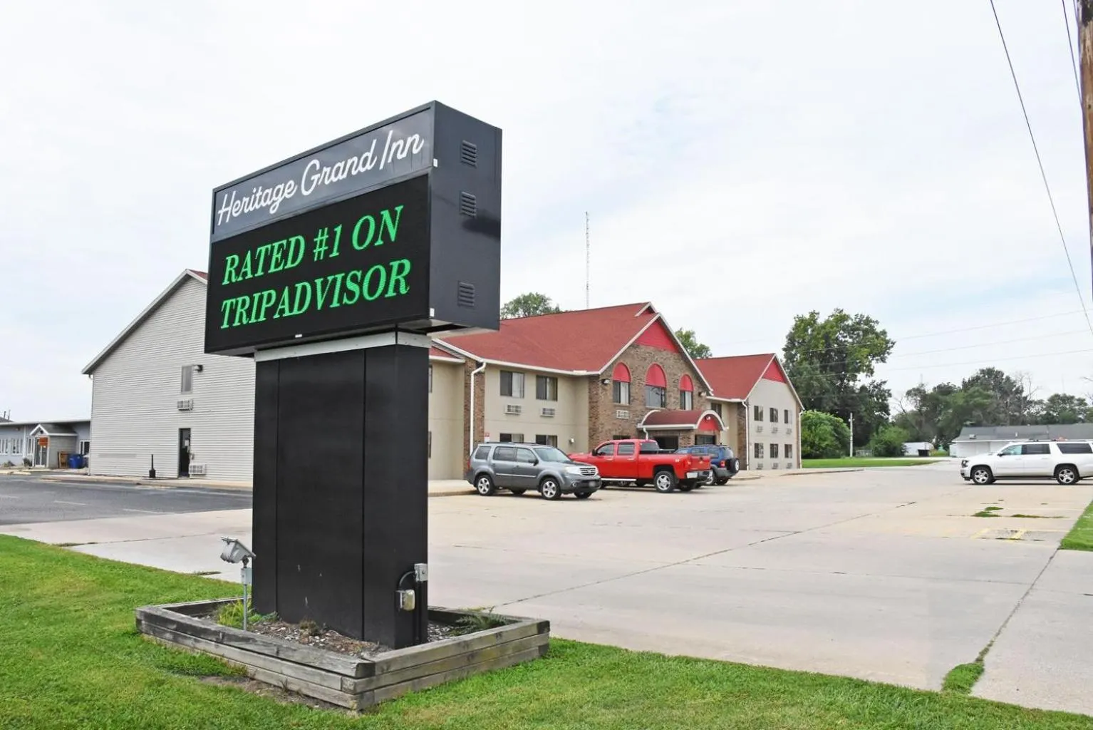 Property logo or sign in Heritage Grand Inn