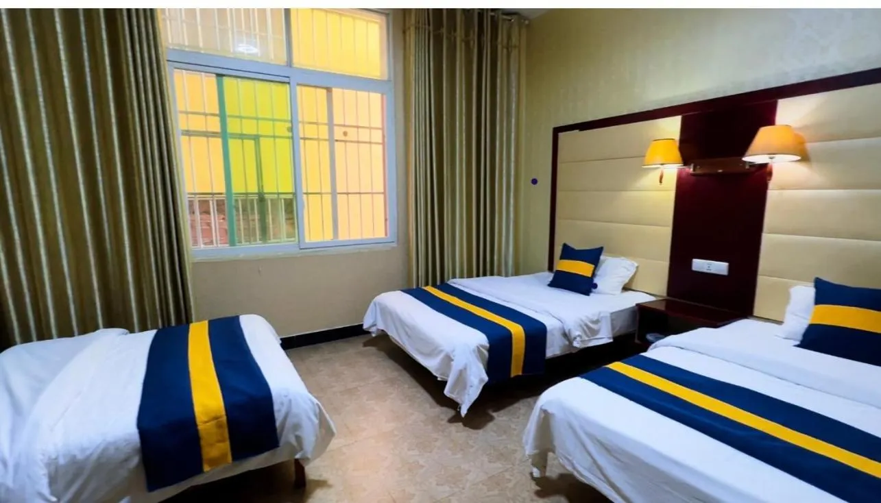 Photo of the whole room, Bed in XiShuangBanNa International Aerial Garden South of Mekong River Business Hotel 傣江南商务酒店