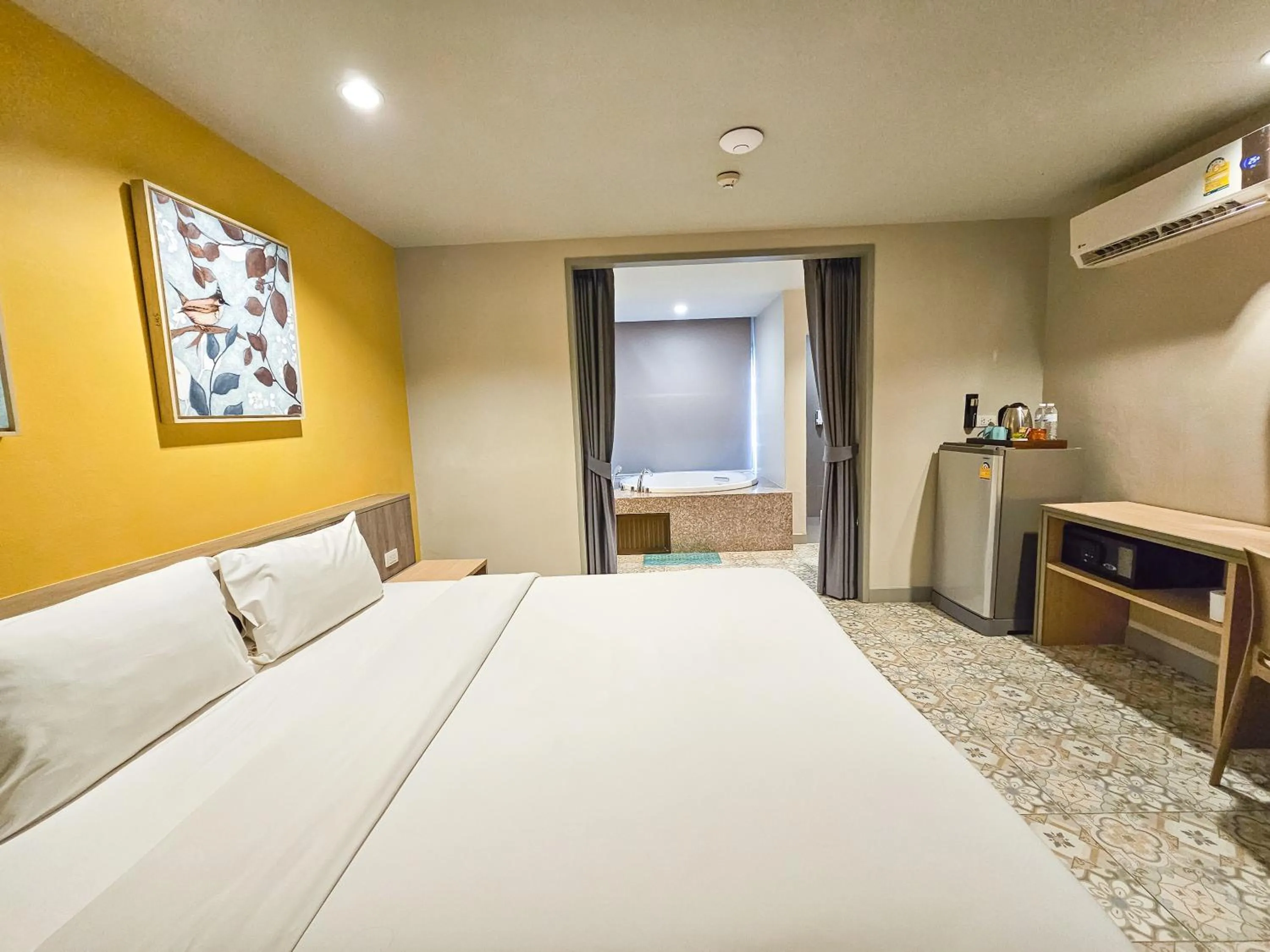 Bed in Recenta Suite Phuket Suanluang