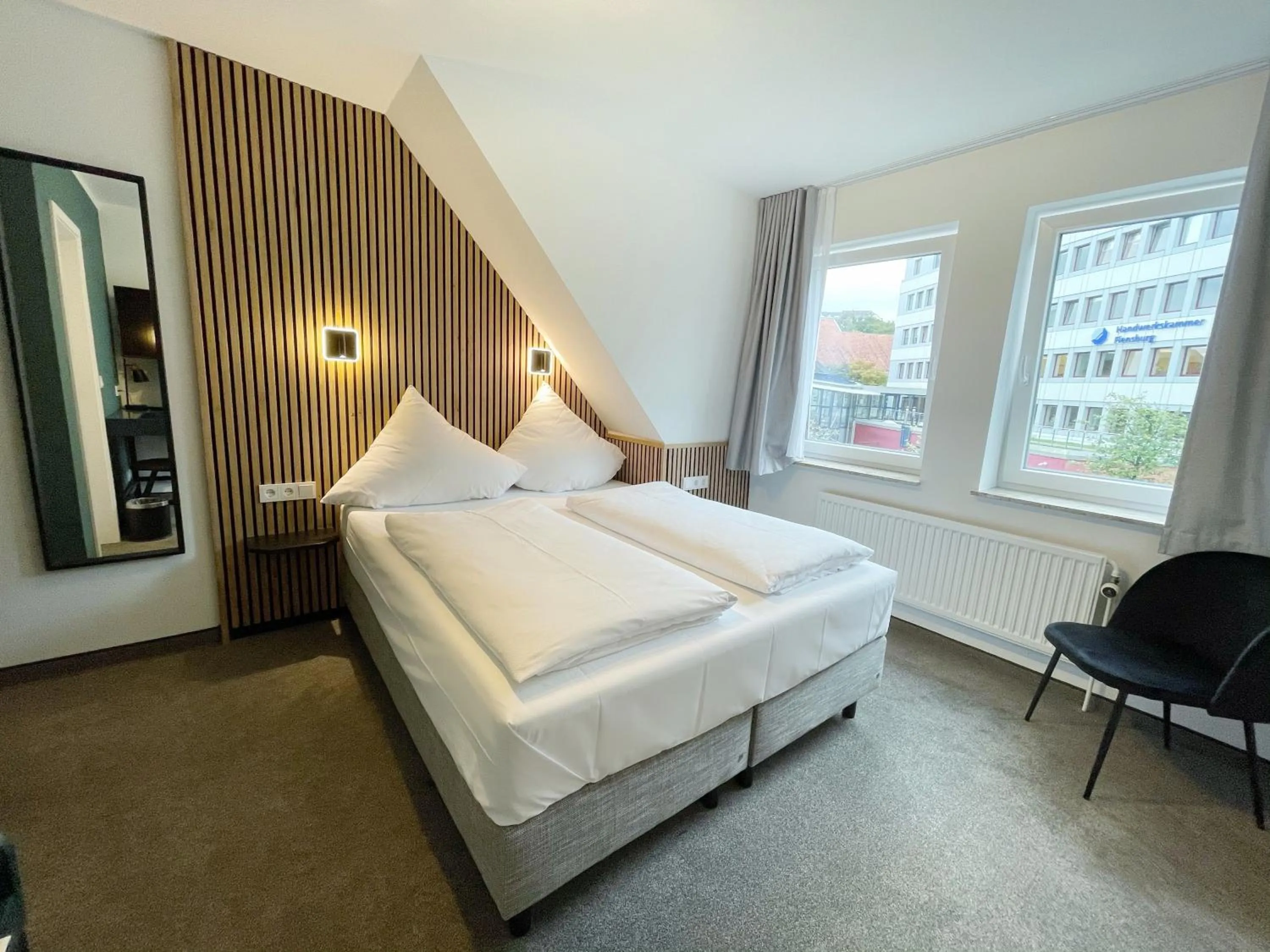 Photo of the whole room, Bed in Hotel Xenia Flensburg