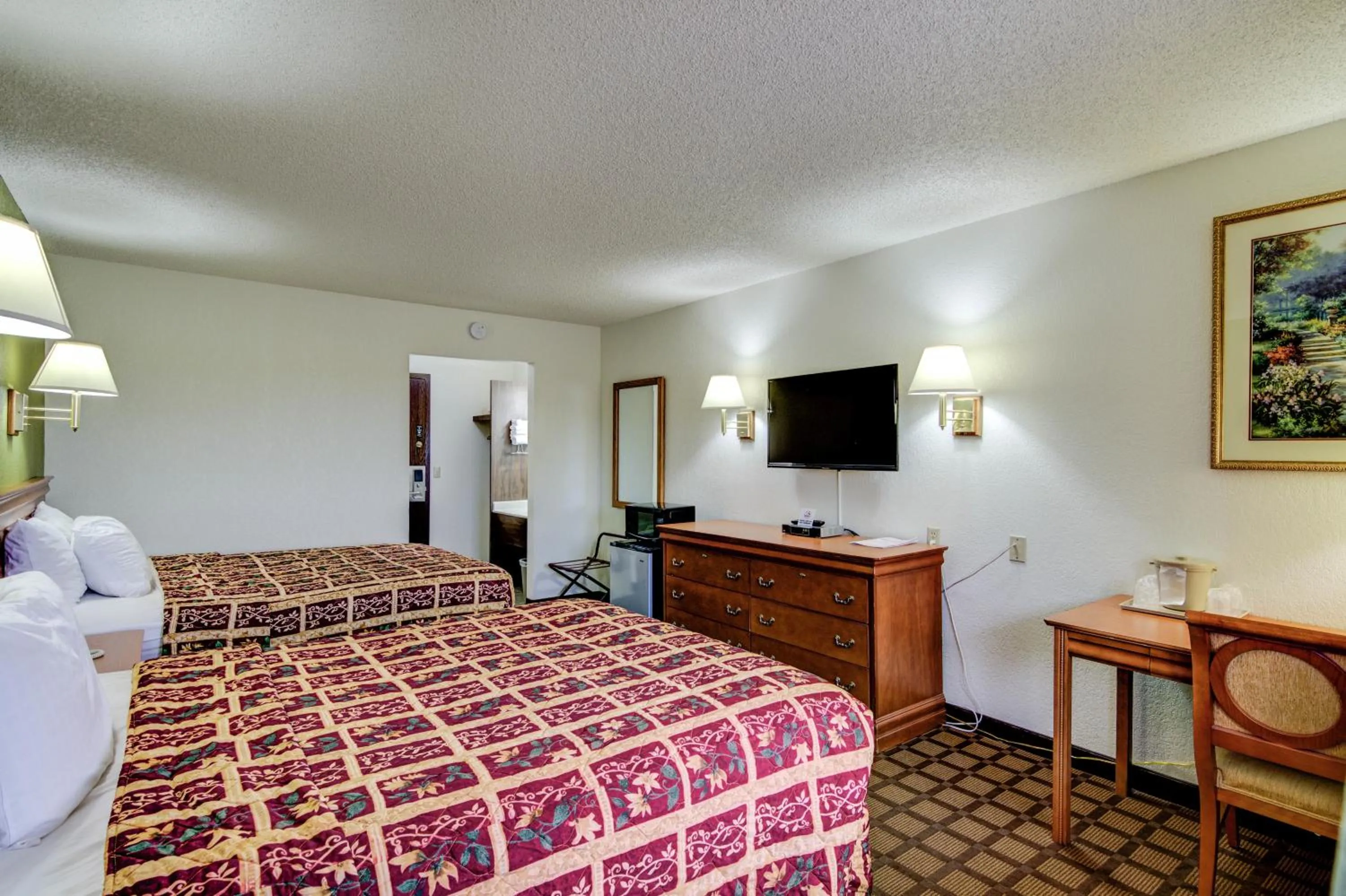 Bed in Bloomer Inn & Suites