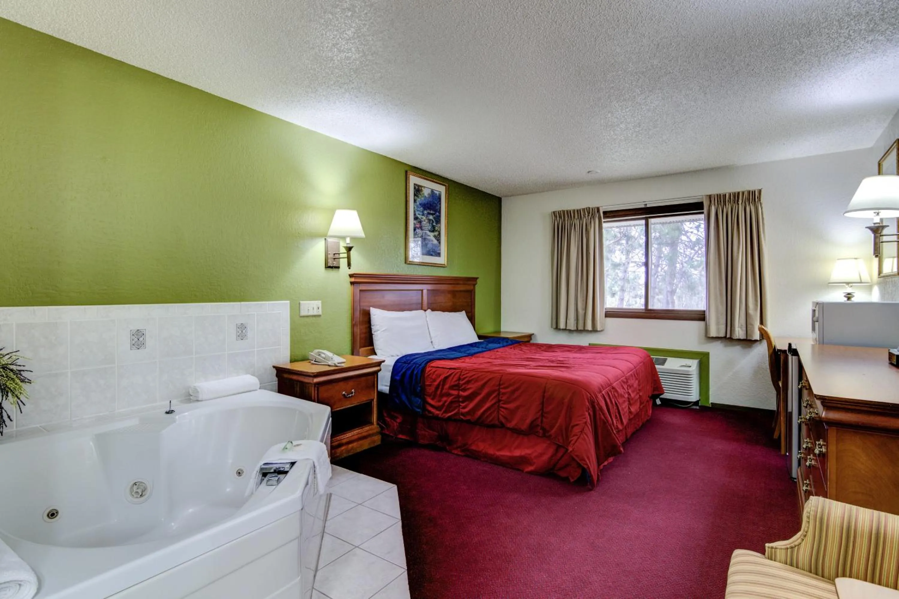 Bed in Bloomer Inn & Suites