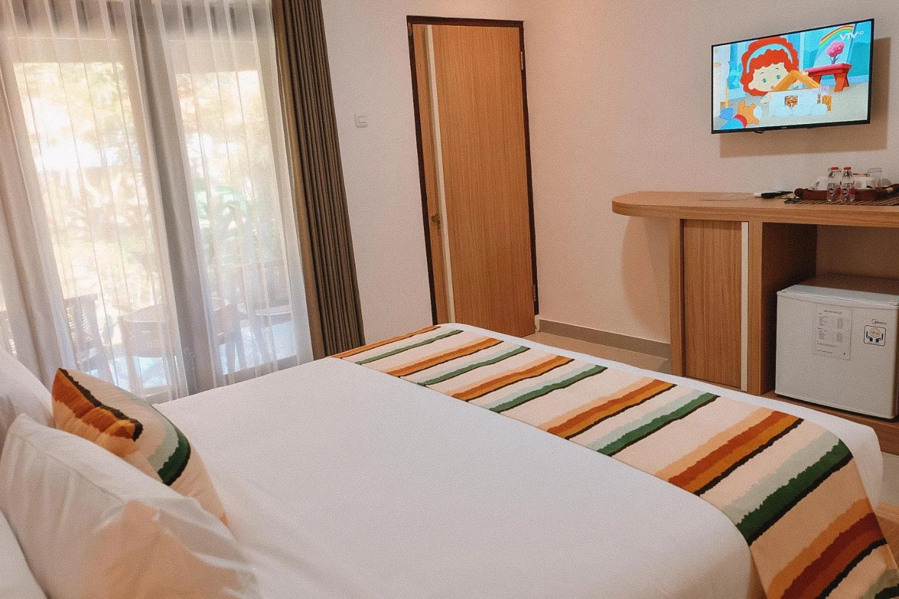 Communal lounge/ TV room, Bed in Bali Wirasana Inn