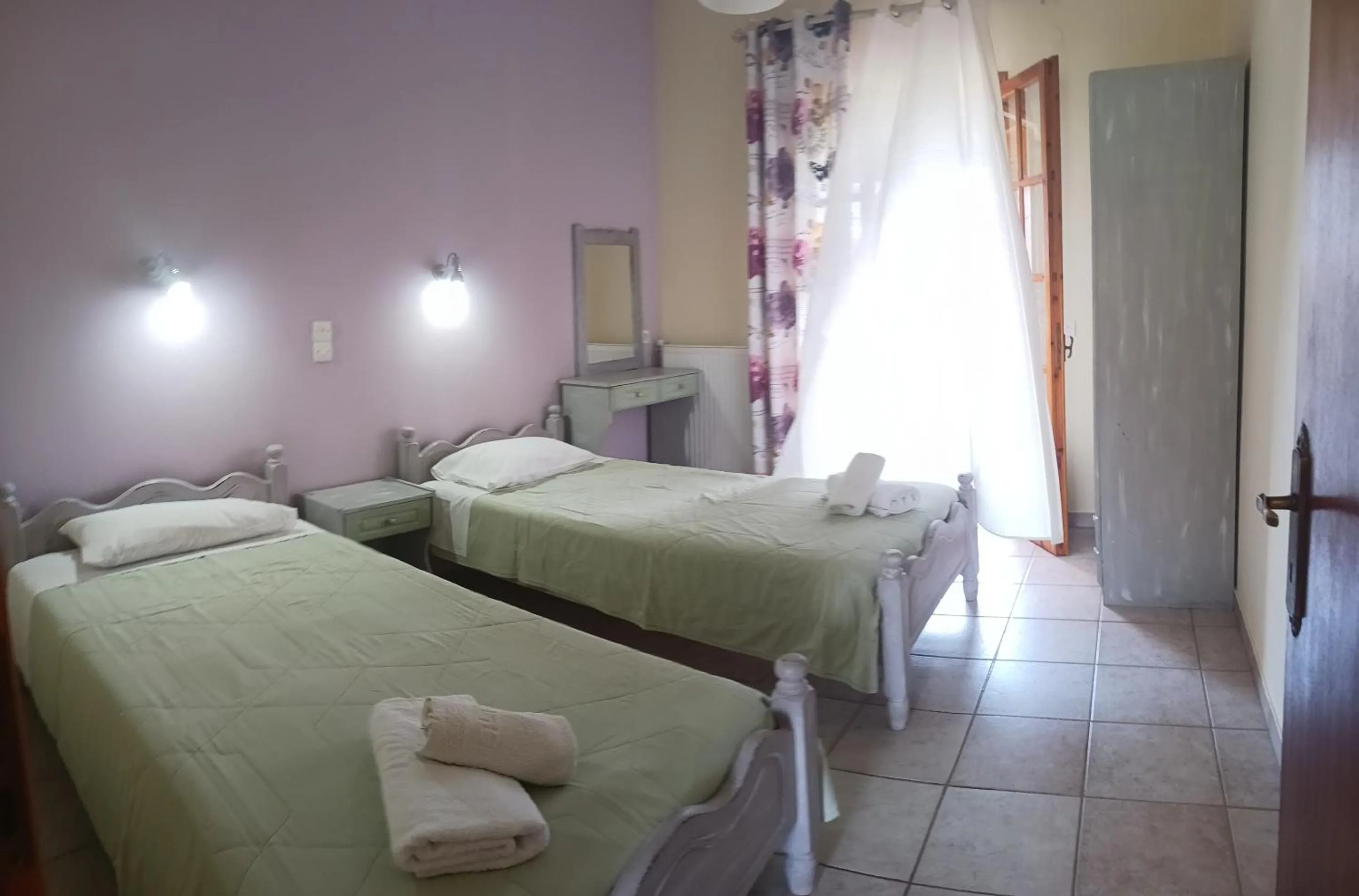 Bed in Olga's Garden Apartments