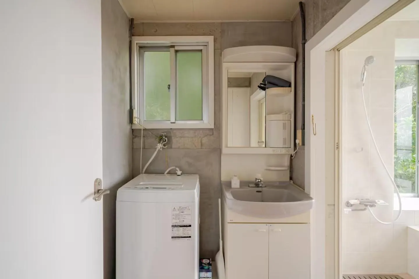 washing machine in PANORAMA Ocean View Cottage