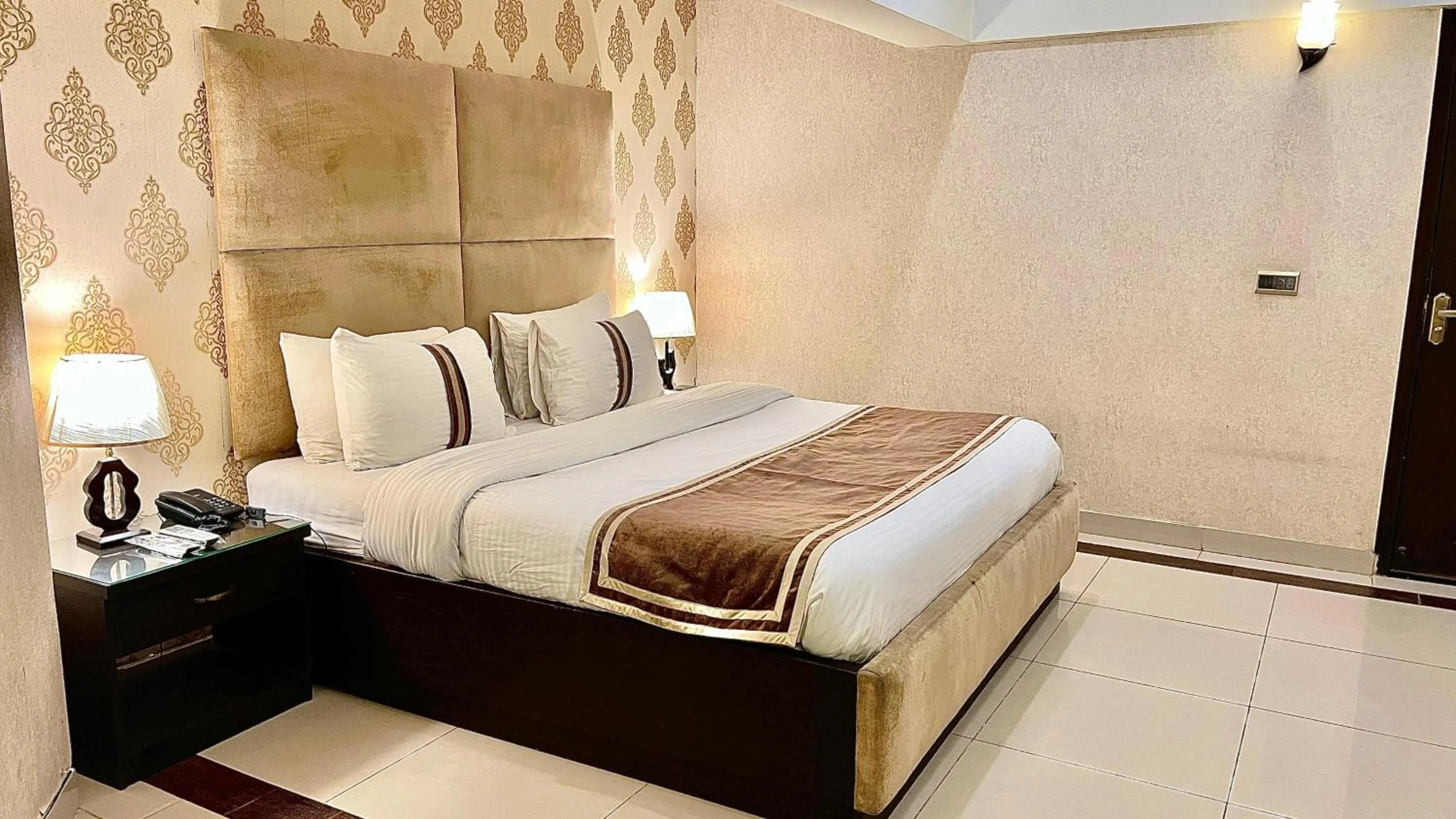 Bed in Royal Inn Hotel