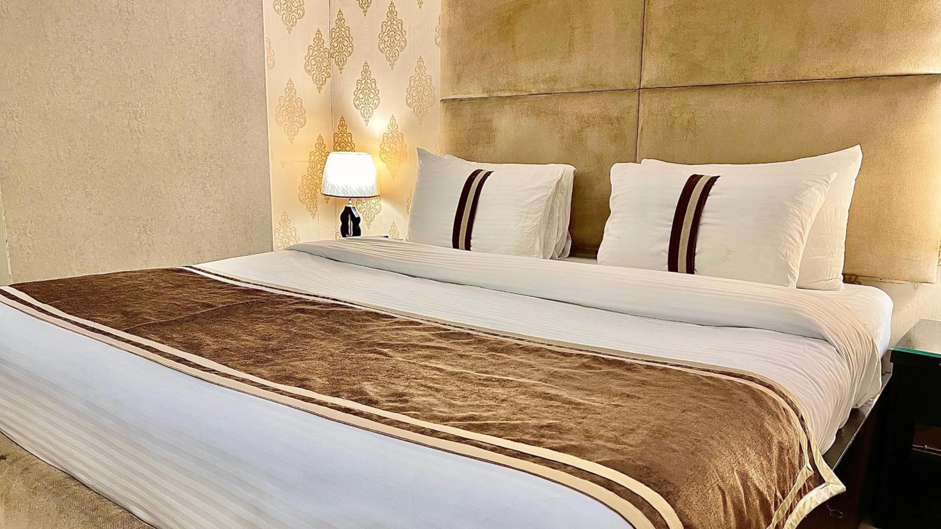 Bed in Royal Inn Hotel