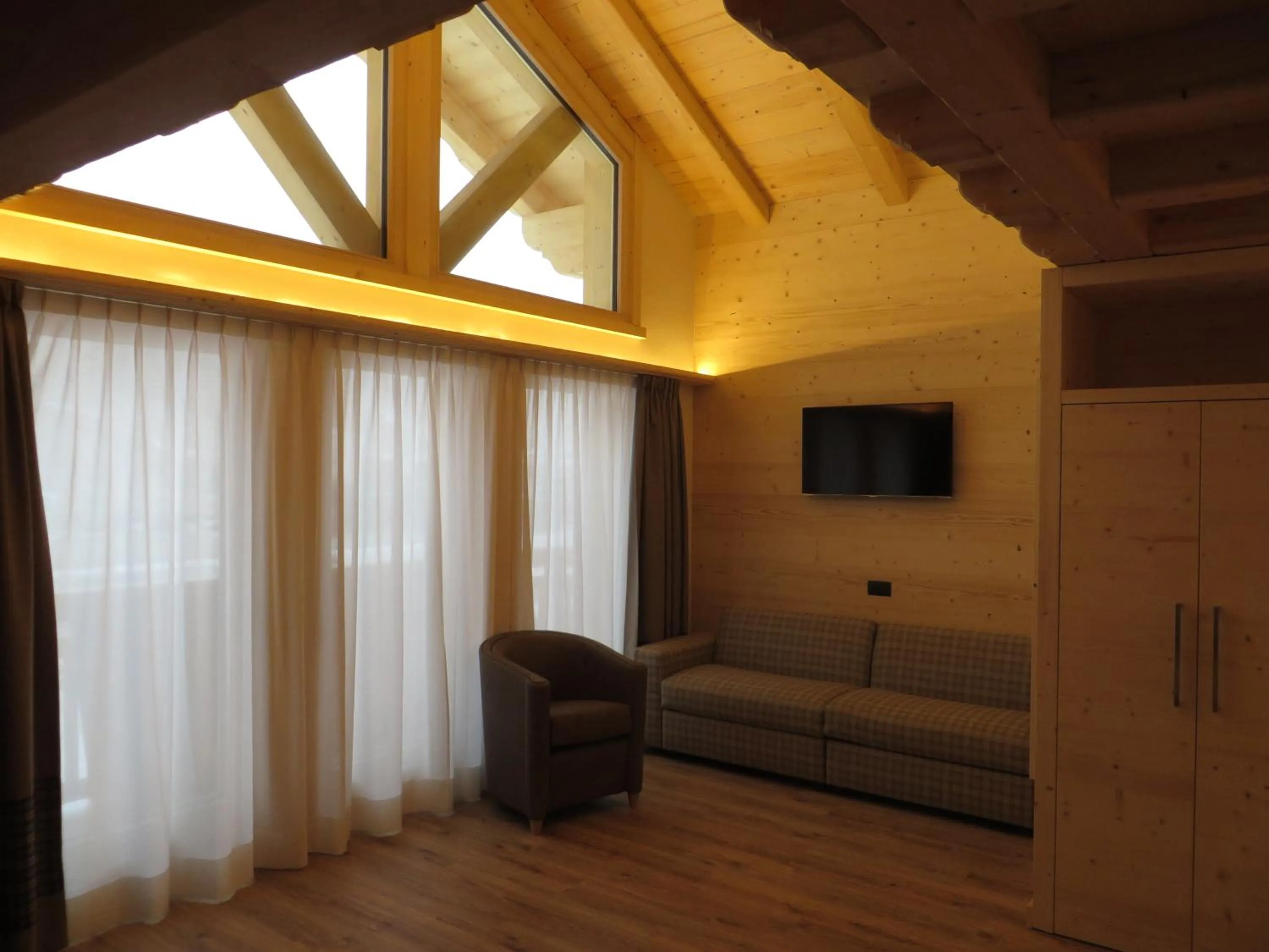 Communal lounge/ TV room in B&B Ecohotel Chalet des Alpes