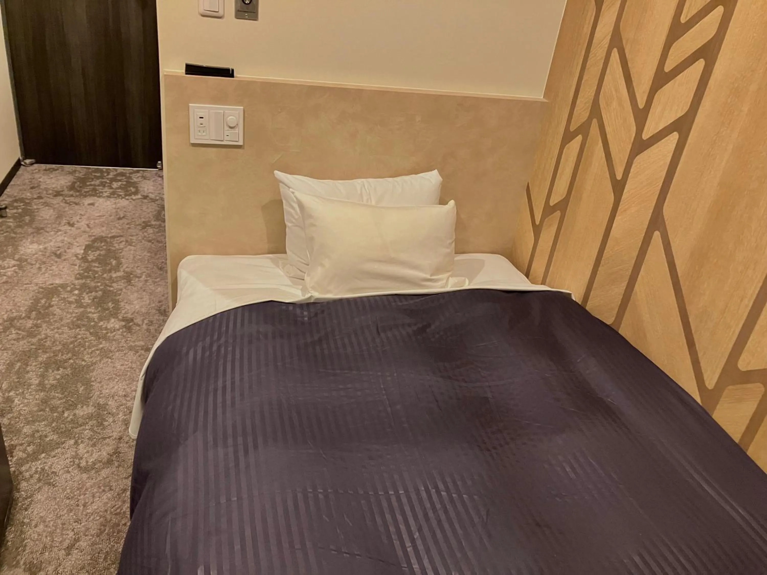 Bed in HOTEL LiVEMAX Mihara Ekimae